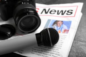 newspaper,with,microphone,and,photo,camera,on,dark,background,,closeup